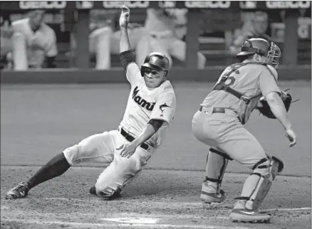  ?? David Santiago Miami Herald ?? DODGERS catcher Will Smith waits for the throw home as the Marlins’ Curtis Granderson slides safely to score during the fifth inning at Marlins Park in Miami. The Marlins netted six runs in the inning, chasing an inconsiste­nt Walker Buehler in the process.