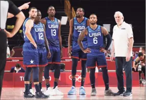  ?? Gregory Shamus / Getty Images ?? From left, Zach Lavine, Jrue Holiday, Bam Adebayo, Kevin Durant, Damian Lillard and coach Gregg Popovich of the United States look on during their game against France.