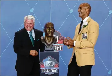  ?? GENE J. PUSKAR / ASSOCIATED PRESS ?? Jason Taylor laughs with his presenter, former coach Jimmy Johnson, during Taylor’s Hall of Fame induction. The Dolphins have retired only Nos. 12 (Bob Griese), 13 (Dan Marino) and 39 (Larry Csonka).