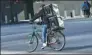  ?? SETH WENIG VIA AP ?? A delivery man rides an electronic bike in New York on Thursday.