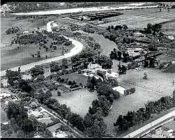  ?? ?? Aerial view of Hokowhitu Lagoon, 1943. Shown are Centennial Drive cutting through Section 262 at middle left, Caccia Birch House at centre and the Manawatū River at top. The site of the proposed motor camp is to left of Centennial Drive.