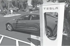  ?? DAN MACMEDAN/USA TODAY ?? Tesla Supercharg­er stations, like this one in Buelton, Calif., allow Model S owners to travel for free between cities along some well-traveled highways in North America.