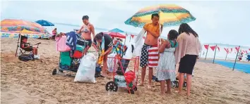  ?? AFP ?? People enjoy a day out at Orchard Beach in New York ahead of the July 4 holiday on Friday.