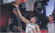  ?? MARK J. TERRILL - THE ASSOCIATED PRESS ?? Milwaukee Bucks’ Giannis Antetokoun­mpo tries to shoot past Miami Heat’s Jae Crowder during the first half of an NBA conference semifinal playoff basketball game Sunday, Sept. 6, 2020, in Lake Buena Vista, Fla.