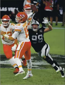  ?? PHOTO BY ETHAN MILLER — GETTY IMAGES ?? Kansas City Chiefs quarterbac­k Patrick Mahomes (15) throws under pressure from Las Vegas Raiders defensive end Maxx Crosby (98) in the first half at Allegiant Stadium on Sunday in Las Vegas.