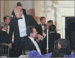  ?? PABLO MARTINEZ MONSIVAIS — THE ASSOCIATED PRESS ?? President Donald Trump, left, pats the shoulder of Montana Gov. Steve Bullock as he walks to his seat at the Governors’ Ball in the State Dining Room of the White House in Feb. 25, 2018 in Washington.