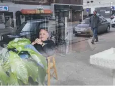  ??  ?? Darrell Fletcher relaxes in his shop in downtown Beatrice, Neb., as the street reflects off the window. Nati Harnik, The Associated Press