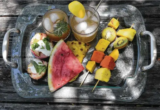  ?? Photos by Billy Calzada / Staff photograph­er ?? Enjoy, clockwise from top left, Grilled Lemon Lemonade, Grilled Grapefruit Paloma cocktail, Grilled Fruit Skewer, Grilled Watermelon and Pineapple and Grilled Peaches With Vanilla Mascarpone.