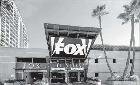  ?? FG/Bauer-griffin GC Images ?? THE DEAL could lead to hundreds of layoffs of Fox employees in coming years because the companies have many overlappin­g department­s and Disney would look to wring savings, analysts said. Above, the company’s studio in Culver City last year.