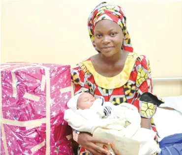  ?? Photo: NAN ?? Mother of the New Year baby, Hajia Hauwa Ibrahim Gobe, with her baby, after the visit by the Bauchi State governor’s wife, Hajia Hadiza Abubukar, at the Specialist General Hospital in Bauchi yesterday