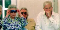  ?? ?? Style: the Queen tries Gower’s sunglasses in 1994