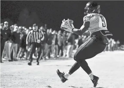  ??  ?? Whitehaven's CorMontae Hamilton (9) receives a pass for a touchdown against Cane Ridge during the second half of the Class 6A semifinal at Cane Ridge High School in Antioch, Tenn., Friday, Nov. 24, 2017. ANDREW NELLES / THE TENNESSEAN