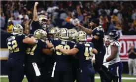  ??  ?? Wil Lutz is swamped by his teammates after clinching the game for the Saints. Photograph: Butch Dill/AP