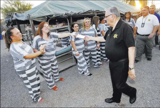  ?? Matt York The Associated Press ?? Maricopa County Sheriff Joe Arpaio signs autographs June 23, 2013, for inmates as he walks through a Maricopa County Sheriff ’s Office jail called “Tent City” in Phoenix. The controvers­ial sheriff ’s career came to an end recently when he lost...