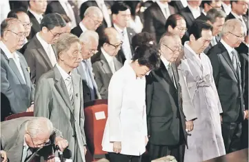  ??  ?? Park (centre) pays her tribute during Korean Liberation Day, a ceremony to celebrate liberation from Japanese colonial rule in 1945, at Seong Cultural Center in Seoul. — AFP photo