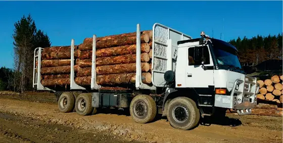  ??  ?? Top: Even with well-worn tyres, the 8x8 all-wheel-drive system enables the Tatra to get up slippery steep slopes.Left: The hydraulica­lly-adjustable tailgate is the key to fast loading, removing the need for chains.Below: A massive test load – although the Tatra is plated to carry 30 tonnes, it was tested with much larger loads, including this one at more than 40 tonnes.