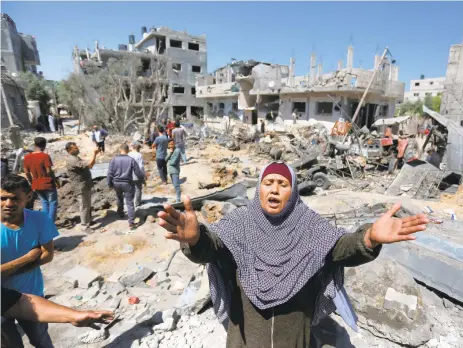  ?? ASHRAF AMRA/TRIBUNE NEWS SERVICE ?? Palestinia­ns assess the damage caused by Israeli airstrikes Friday in Beit Hanoun in the northern Gaza Strip. Israel pounded Gaza and deployed extra troops to the border as Palestinia­ns fired barrages of rockets back.