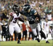  ?? MICHAEL PEREZ - AP ?? The Philadelph­ia Eagles’ Zach Ertz, right, pushes off from the Falcons’ Ricardo Allen during the second half of an NFL game Thursday, in Philadelph­ia.