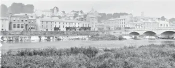 ??  ?? A view of Fermoy town across the Blackwater, c. 1865-1914, showing the weir in full glory. The named business premises on what was Artillery Quay (now O’Neill Crowley Quay), r-l:, E Byrne and JJ Barber. Next to this appears to be a butcher’s shop, as the carcass of an animal can be seen hanging in the window. Across on the opposite side of Queen Square (now Pearse Square) some of the identifiab­le premises include the Royal Hotel and the premises of RB Baker, cycle merchant. From the Lawrence Photograph­ic Collection. (Image courtesy of the National Library of Ireland)