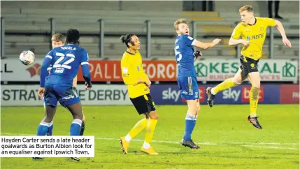  ??  ?? Hayden Carter sends a late header goalwards as Burton Albion look for an equaliser against Ipswich Town.