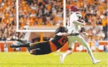  ?? TENNESSEE ATHLETICS PHOTO ?? Tennessee safety Wesley Walker lays out to tackle South Carolina quarterbac­k Spencer Rattler during Saturday night’s 41-20 win by the Volunteers.