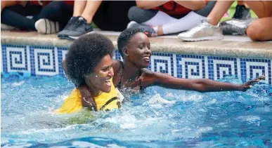  ?? Photo: Miss World Fiji ?? Miss World Fiji Nanise Rainima helping Miss Kenya Magline Jeruto complete her swim.