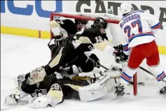  ?? Matt Freed/Post-Gazette ?? The Rangers' Derick Brassard stuck again and left Penguins defensemen Paul Martin (7) and Ben Lovejoy in the net with his gritty goal in the second period. Rangers defenseman Ryan McDonagh checks at the net just to make sure.