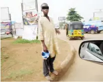  ??  ?? An almajiri begging for alms at a roundabout in Zaria