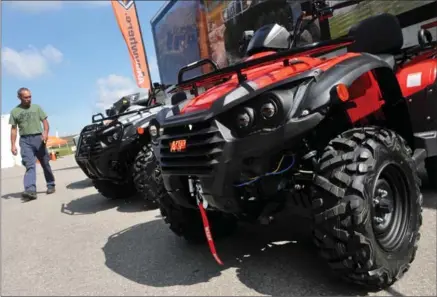  ?? BRENT DAVIS, RECORD STAFF ?? Argo employee Byron Shantz walks past a line of new Argo ATVs at the company’s headquarte­rs in New Hamburg on Wednesday.