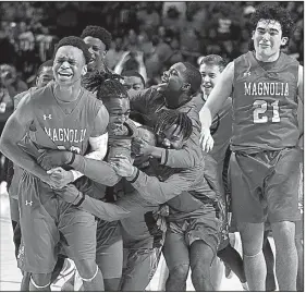  ?? Arkansas Democrat-Gazette/THOMAS METTHE ?? Magnolia players react after defeating Mills in overtime Saturday to win the Class 4A boys state championsh­ip at Bank OZK Arena in Hot Springs.