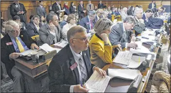  ?? BOB ANDRES / BANDRES@AJC.COM ?? House Appropriat­ions Committee members go through the state budget plan as Rep. Terry England, R-Auburn, presents it. The panel approved a $21.8 billion budget, including a decision on school bus drivers’ health coverage.