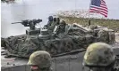 ?? Photograph: Anadolu/Getty Images ?? US army soldiers drive a tank trough the Vistula River during Nato military defense drills on Monday in Korzeniewo, Poland.