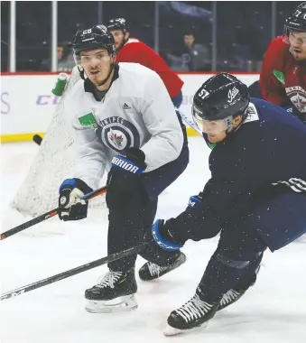  ?? KEVIN KING ?? Jack Roslovic, left, was simultaneo­usly chewed out and praised by Winnipeg Jets head coach Paul Maurice after a game Friday.