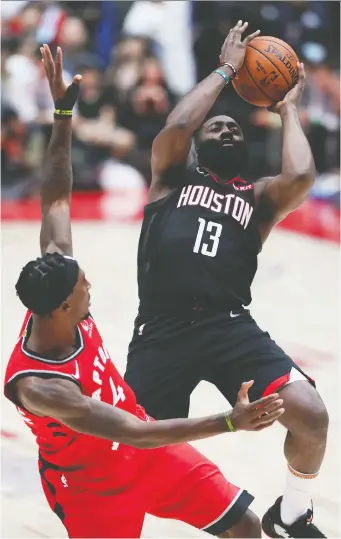 ?? TAKaSHI AOYAMA/GETTY IMAGES ?? James Harden of Houston Rockets shoots against Rondae Hollis-Jefferson of the Toronto Raptors during a pre-season game at Saitama Super Arena on Tuesday in Saitama, Japan.