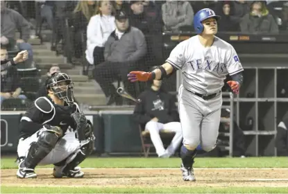  ??  ?? The Rangers’ Shin- Soo Choo hits a grand slam in the third inning Friday against the White Sox at Guaranteed Rate Field.