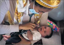  ??  ?? Student midwife Maryam Karim checks the heartbeat of Stokes’ baby, Nikko, during a postpartum visit to the South L.A. birthing center on May 26.