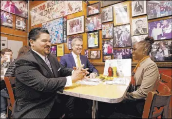  ?? The Associated Press file ?? New York City Schools Chancellor Richard Carranza, left, has lunch with New York Mayor Bill de Blasio and first lady Chirlane McCray in April 2018 at Katz’s Delicatess­en in New York City. Carranza announced Friday that he would step down.