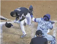  ?? Jonathan Daniel / Getty Images ?? The White Sox’ Tim Anderson is hit by a pitch by the Royals’ Glenn Sparkman in the second inning.