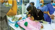  ?? (AFP) ?? The Yemeni mother of conjoined twins checking on them following their separation in the capital Riyadh on Sunday