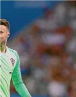  ?? AP, GETTY IMAGES ?? Croatia goalkeeper Danujel Subasic, left, waves to fans after their win over Russia yesterday. At right, England’s Harry Maquire is known as Slab Head by team-mates thanks to Jamie Vardy.