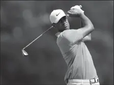  ?? MATTHEW STOCKMAN/GETTY IMAGES/TNS ?? Tony Finau plays his shot from the 7th tee during the second round of the 3M Open on Friday, at TPC Twin Cities in Blaine, Minn.