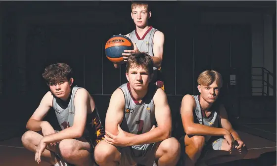  ??  ?? Southern Cross’ Adam Beaton (back), Kaelen Culpitt, Joseph Maher and Riley Dennis before the Champion Basketball Schools of Queensland. Picture: Matthew Elkerton