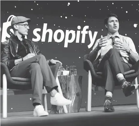  ?? THE CANADIAN PRESS/NATHAN DENETTE ORG XMIT: NSD505 ?? Prime Minister Justin Trudeau participat­es in an armchair discussion with Shopify CEO Tobias Lutke in Toronto on May 8. Spotify gets the vast majority of its revenue from outside of Canada.