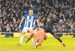  ?? ALASTAIR GRANT AP ?? Arsenal’s Eddie Nketiah (right) scores his side’s third goal against goalie Robert Sanchez (1) during their EPL match at Brighton and Hove Albion on Saturday.