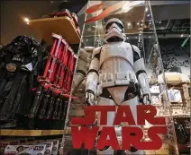  ?? JEENAH MOON / BLOOMBERG 2017 ?? A “Star Wars” storm trooper model is displayed at a Disney Store in New York City. Sales of “Star Wars” playthings were down in 2017 despite a new film, “Star Wars: The Last Jedi,” being released during the holiday season.