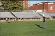  ??  ?? Chico State men’s ultimate frisbee club president John Anthony, left, throws a frisbee to teammate Jonny Nguyen on Thursday at University Stadium.