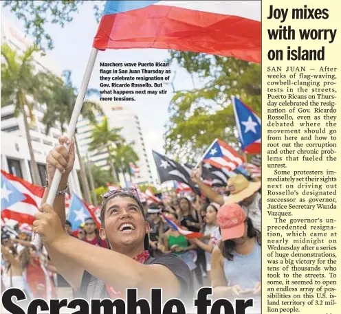  ??  ?? Marchers wave Puerto Rican flags in San Juan Thursday as they celebrate resignatio­n of Gov. Ricardo Rossello. But what happens next may stir more tensions.