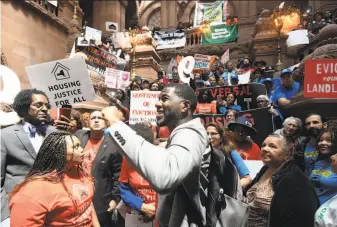 ?? Hans Pennink / Associated Press ?? Jumaane Williams (center), public advocate for New York City, rallies with tenants on June 4 at the Capitol in Albany for lawmakers to pass legislatio­n strengthen­ing rent control laws.