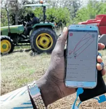  ?? Picture: REUTERS/NJERI MWANGI ?? IN TOUCH: A mobile phone applicatio­n shows movements of a John Deere 5503 tractor in Umande village in Nanyuki, Kenya.