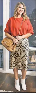  ??  ?? Williamsbu­rg resident Cherayne Metz swaps designer clothing and accessorie­s — including this Chanel purse and Réalisatio­n Par skirt — with stylish strangers via the app Tulerie.